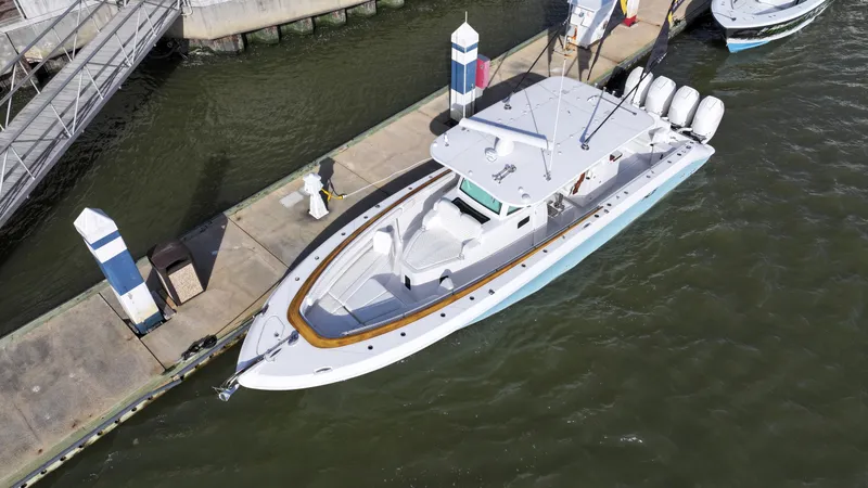 Slide: The Image of Aerial view of 2025 HCB Lujo yacht docked at marina with multiple outboard engines. - 3