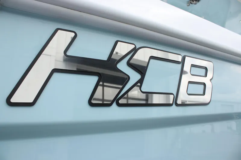 Slide: The Image of HCB Lujo 2025 logo on light blue boat exterior. - 34