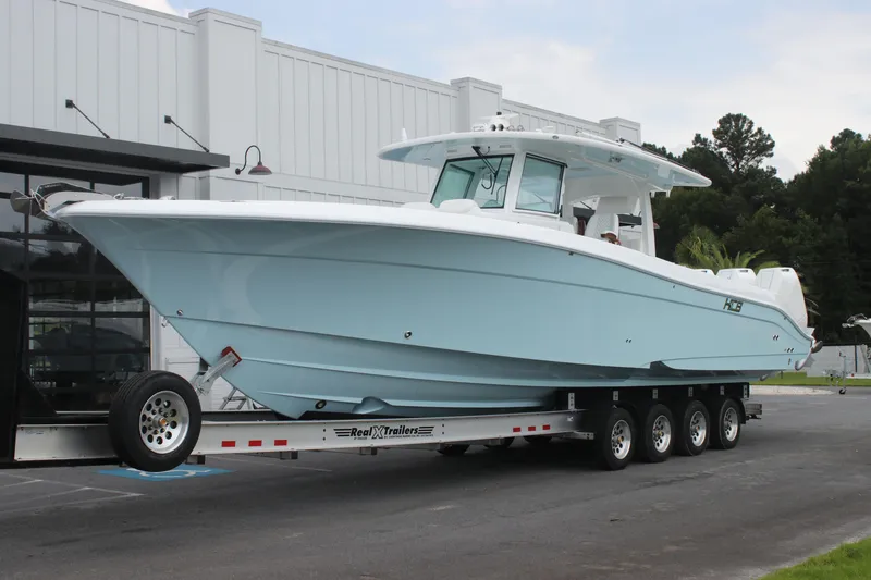 Slide: The Image of 2025 HCB Lujo boat on trailer outside a building. - 4