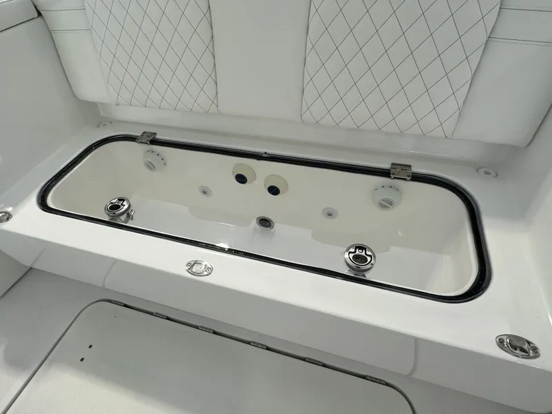 Slide: The Image of 2025 HCB Lujo boat interior with diamond-stitched seating and built-in storage compartment. - 40