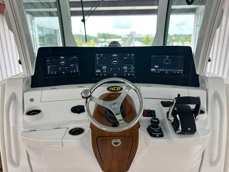 Slide: The Image of Helm of 2025 HCB Lujo boat with modern controls and digital displays. - 44