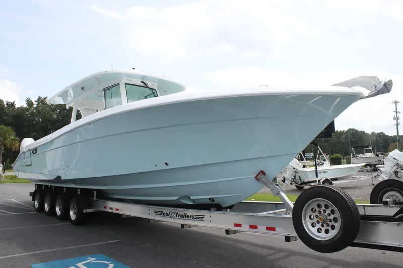 Slide: The Image of 2025 HCB Lujo boat on trailer, parked outdoors. - 7