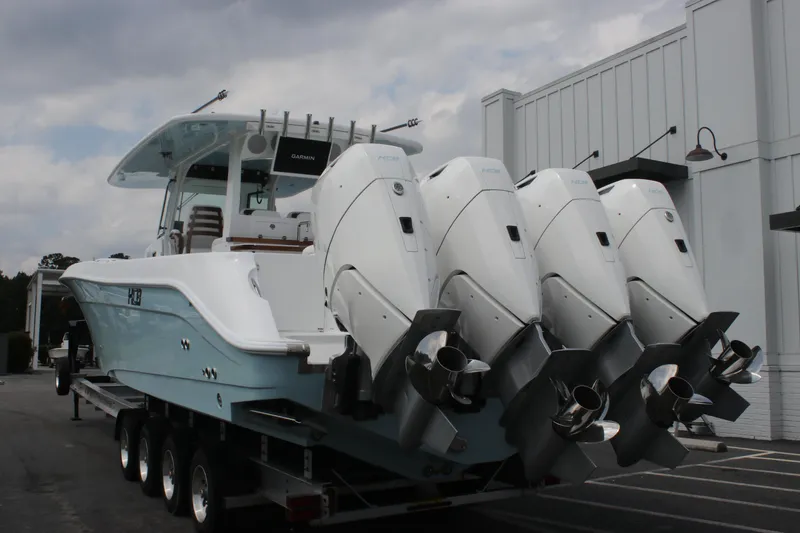 Slide: The Image of 2025 HCB Lujo boat with four powerful outboard engines on a trailer. - 9
