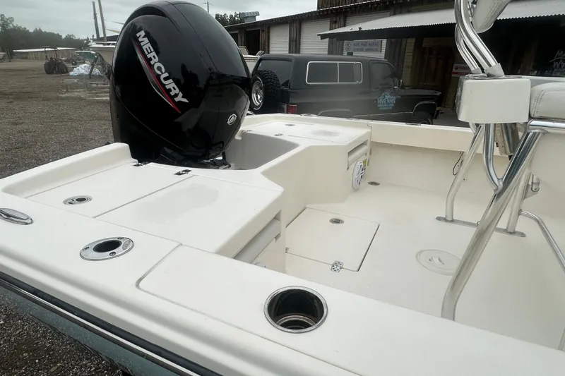 Slide: The Image of Pathfinder 2005 TRS boat with Mercury engine, 2023 model, docked outdoors. - 11