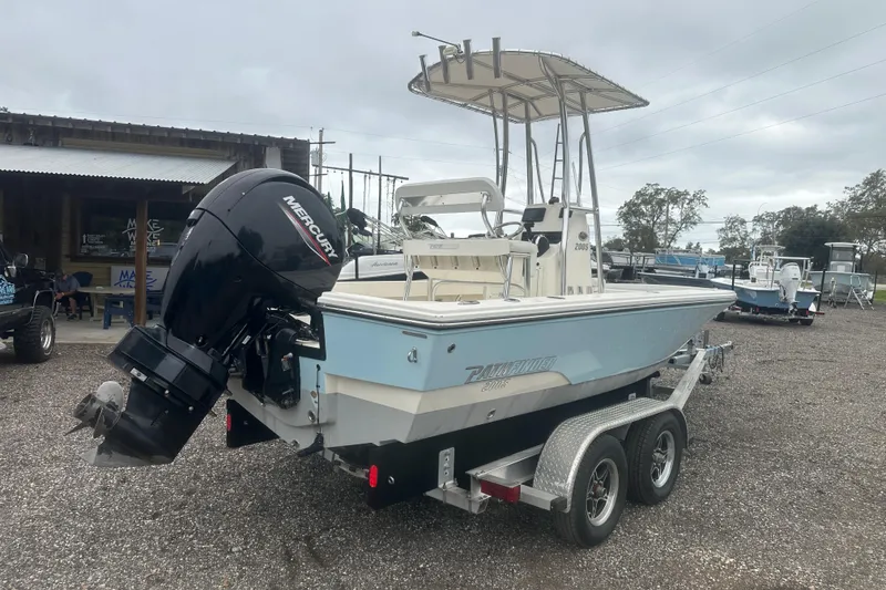 Slide: The Image of Pathfinder 2005 TRS boat on trailer with Mercury outboard motor, parked outdoors. - 5