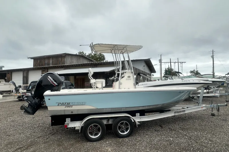 Slide: The Image of Pathfinder 2005 TRS boat on trailer, featuring Mercury outboard motor, parked outdoors. - 6