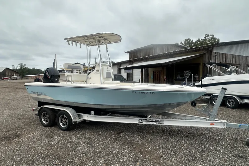 Slide: The Image of Pathfinder 2005 TRS boat on trailer, parked outdoors, overcast sky. - 7