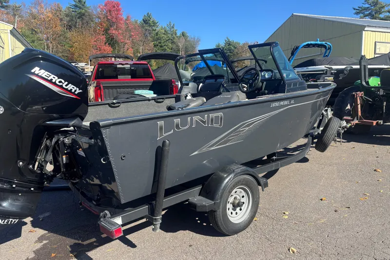 Slide: The Image of 2021 Lund 1650 Rebel XL Sport boat with Mercury engine on trailer. - 9