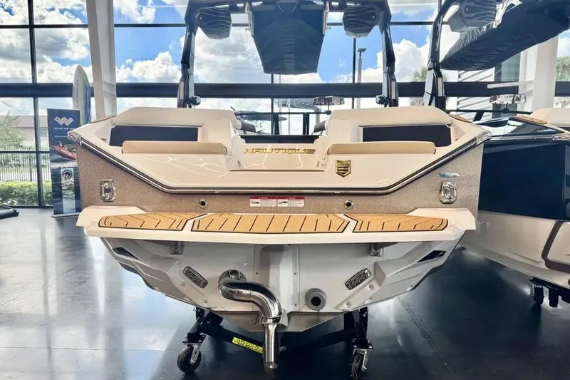 Slide: The Image of 2026 Nautique Super Air Nautique S23 boat displayed indoors, rear view. - 3
