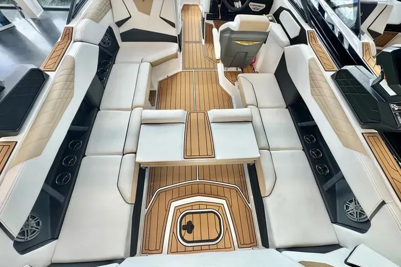 Slide: The Image of 2026 Nautique Super Air Nautique S23 interior with luxurious seating and wood accents. - 5