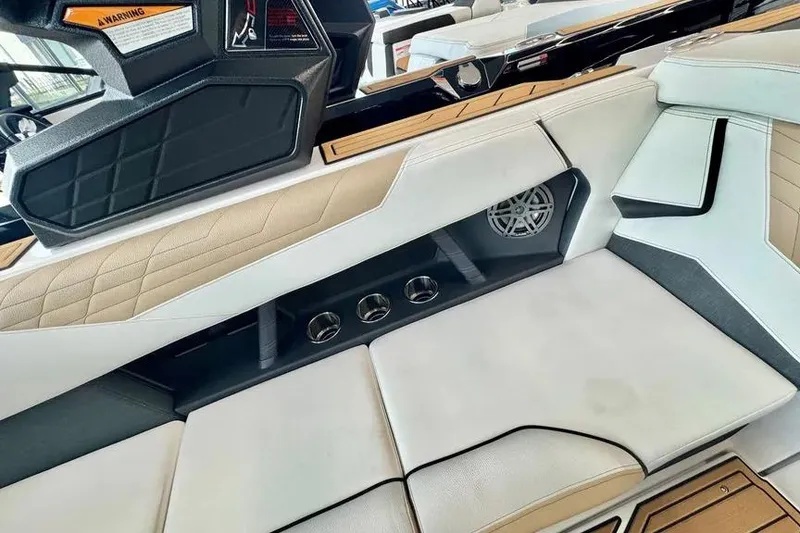 Slide: The Image of 2026 Nautique Super Air Nautique S23 interior with luxurious seating and speaker system. - 9