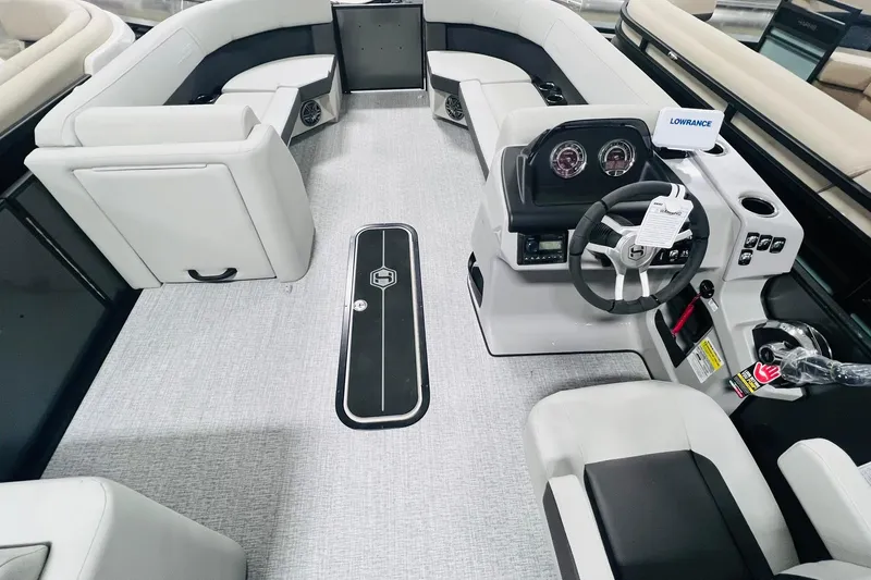 Slide: The Image of 2025 Harris Cruiser 230 boat interior with modern helm and seating. - 10
