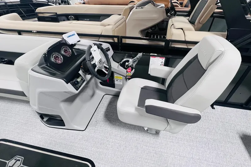 Slide: The Image of 2025 Harris Cruiser 230 boat interior with steering console and captain's chair. - 13