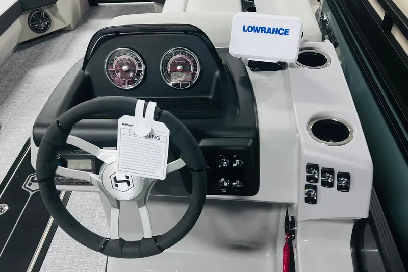 Slide: The Image of Steering console of 2025 Harris Cruiser 230 with Lowrance display and control panel. - 15