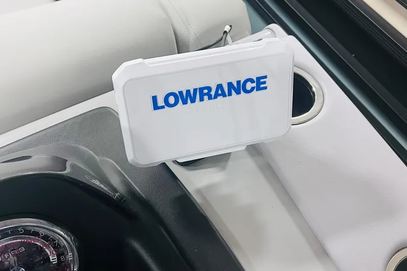 Slide: The Image of Lowrance device on 2025 Harris Cruiser 230 dashboard, near cup holder. - 17