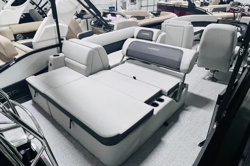 Slide: The Image of 2025 Harris Cruiser 230 boat interior with gray seating and cup holders. - 25