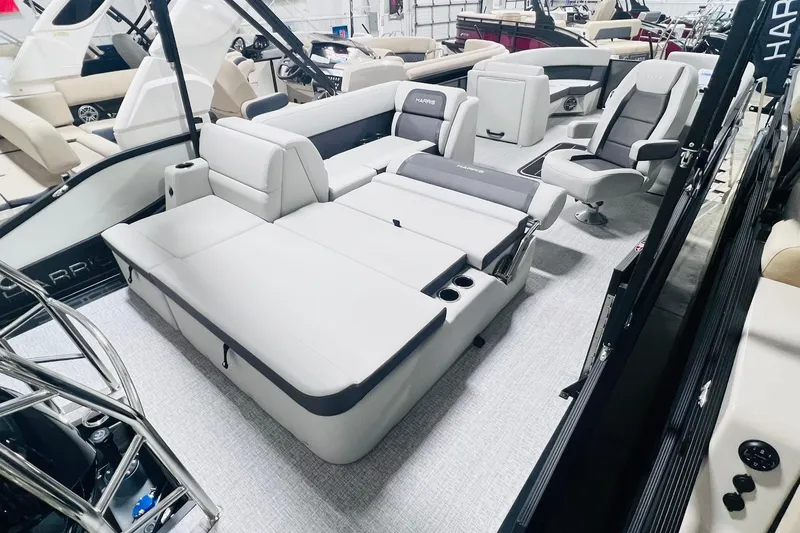 Slide: The Image of 2025 Harris Cruiser 230 interior with luxurious seating and modern design in a showroom. - 28