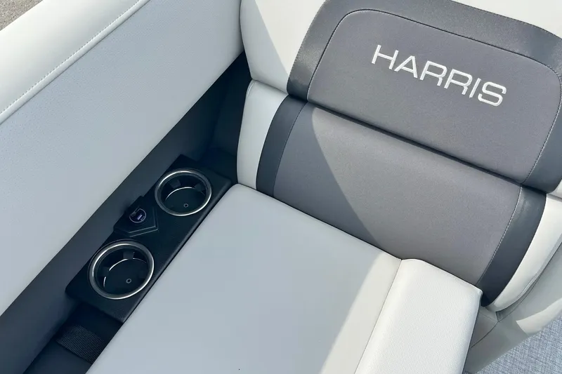 Slide: The Image of 2025 Harris Cruiser 230 boat seat with cup holders and logo detail. - 33