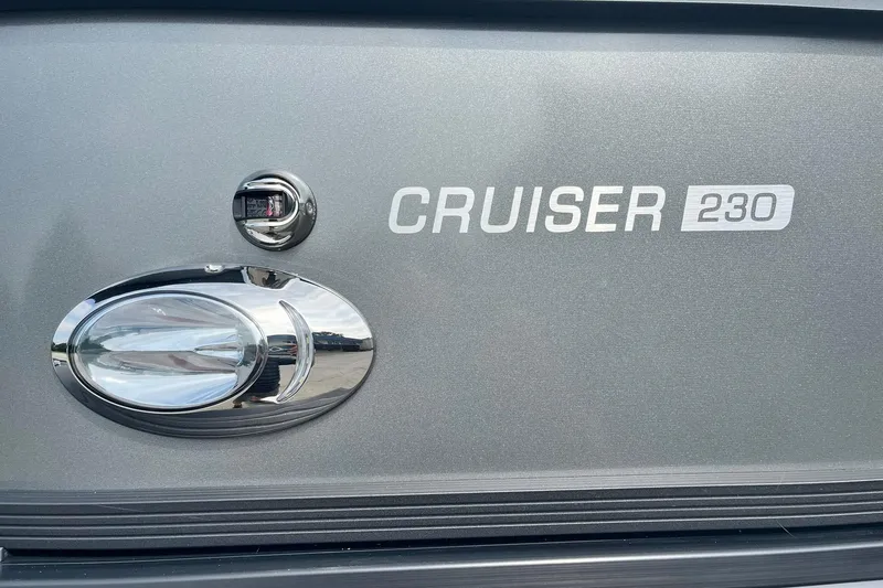 Slide: The Image of 2025 Harris Cruiser 230 boat emblem on metallic surface. - 36