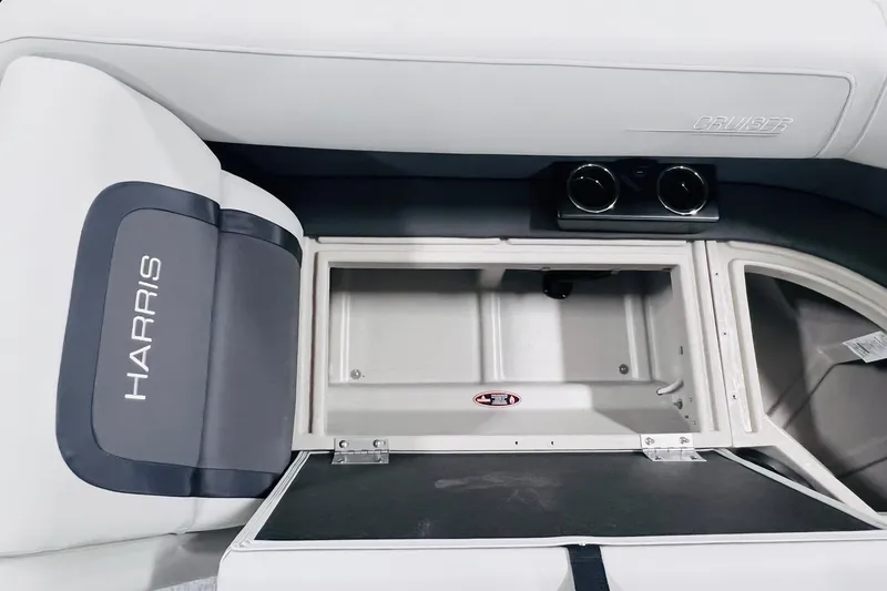 Slide: The Image of 2025 Harris Cruiser 230 boat interior with storage compartment and cup holders. - 41