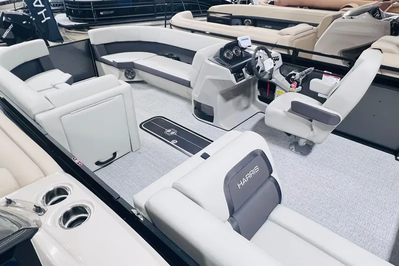 Slide: The Image of Interior of 2025 Harris Cruiser 230 boat with modern seating and steering console. - 7