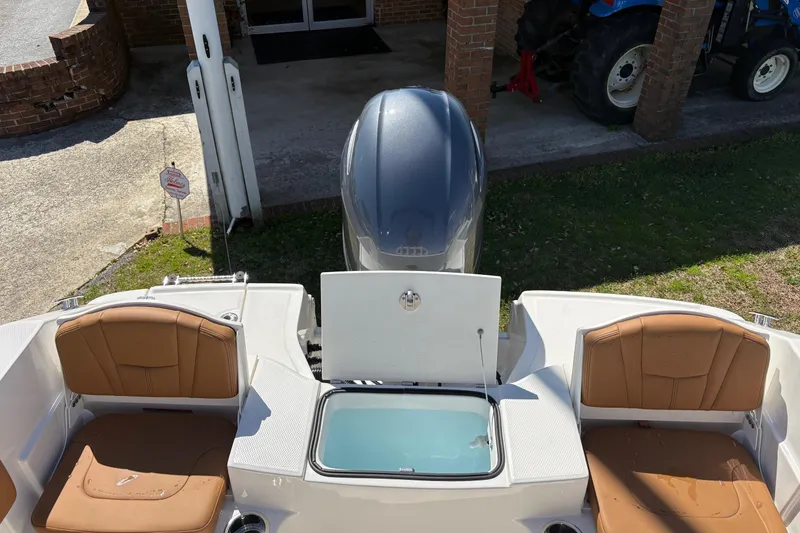 Slide: The Image of 2026 Robalo R180 Center Console boat with open storage compartment and seating. - 11