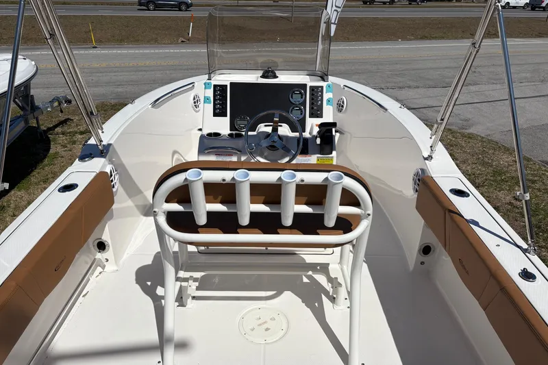 Slide: The Image of 2026 Robalo R180 Center Console boat interior with steering wheel and rod holders. - 13