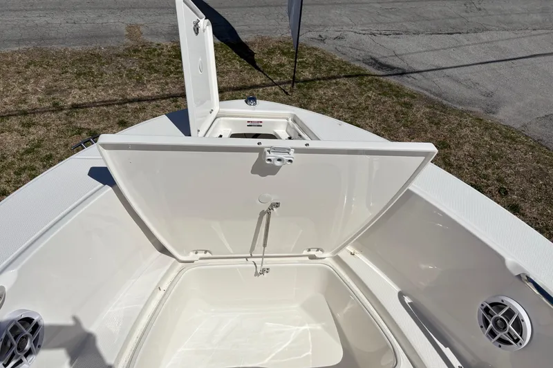 Slide: The Image of 2026 Robalo R180 Center Console boat with open storage compartment. - 7