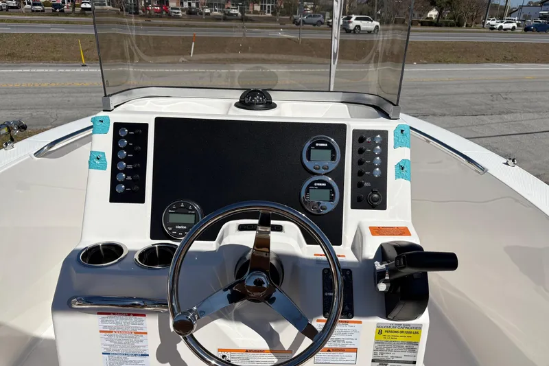Slide: The Image of 2026 Robalo R180 Center Console boat dashboard with steering wheel and controls. - 9