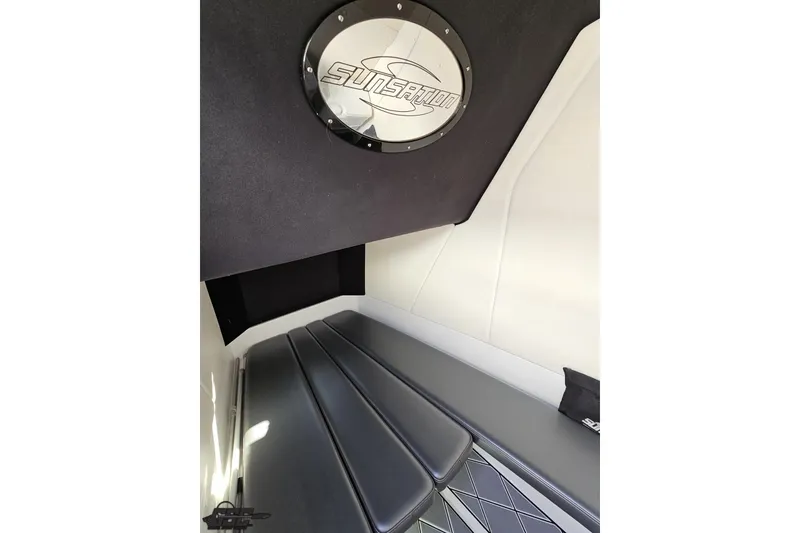 Slide: The Image of 2020 Sunsation 32 CCX cabin interior with sleek black seating and logo detail. - 118