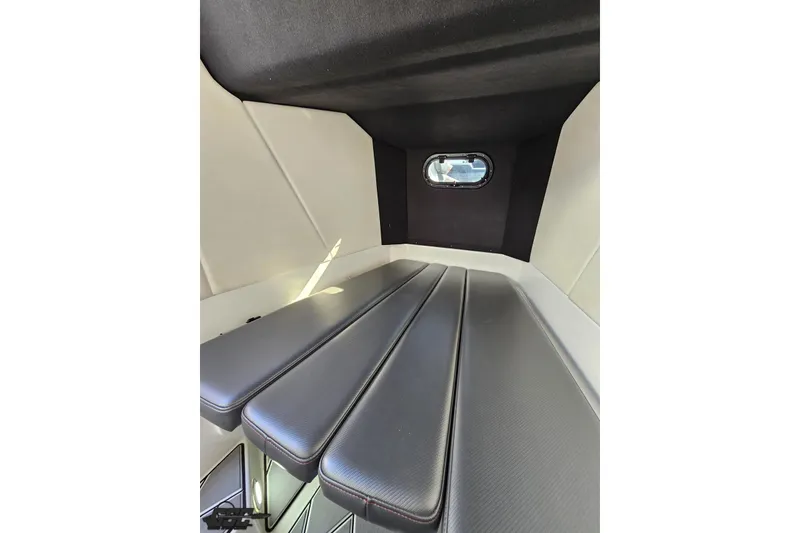 Slide: The Image of 2020 Sunsation 32 CCX cabin interior with cushioned seating and small window. - 120