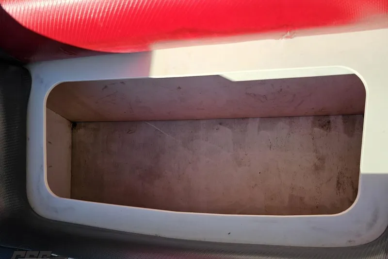 Slide: The Image of Storage compartment in 2020 Sunsation 32 CCX boat, featuring red and white interior. - 132