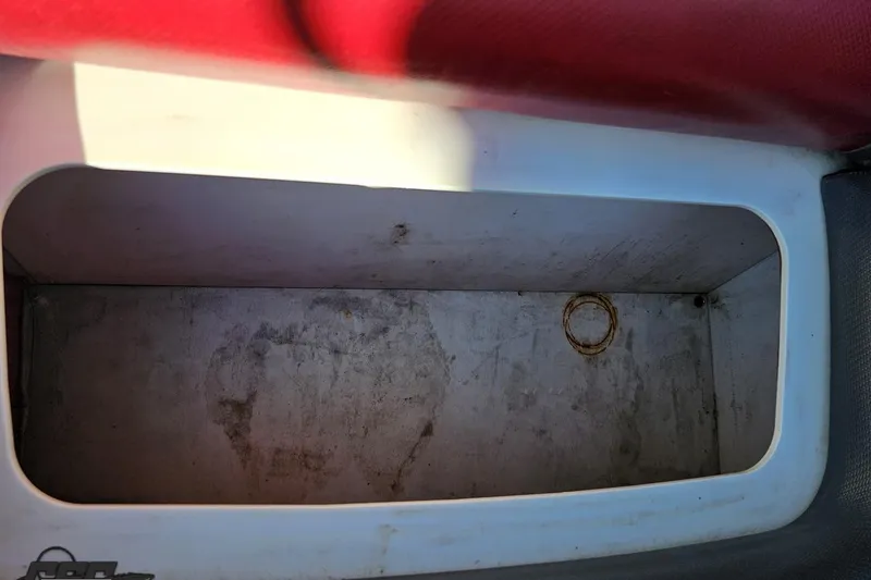 Slide: The Image of Storage compartment in a 2020 Sunsation 32 CCX boat, featuring a red and white interior. - 134