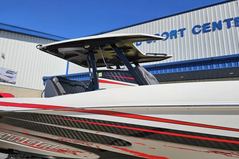 Slide: The Image of 2020 Sunsation 32 CCX boat with sleek design, red accents, and modern T-top. - 16