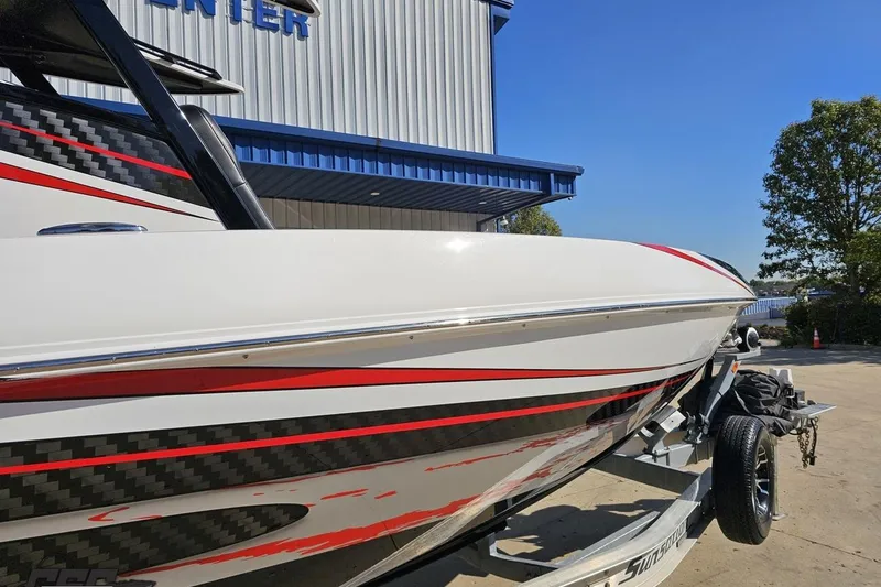 Slide: The Image of 2020 Sunsation 32 CCX boat with sleek design and red accents on a trailer. - 18