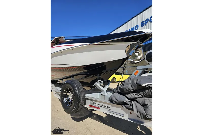 Slide: The Image of 2020 Sunsation 32 CCX boat on trailer, parked outdoors under clear blue sky. - 22