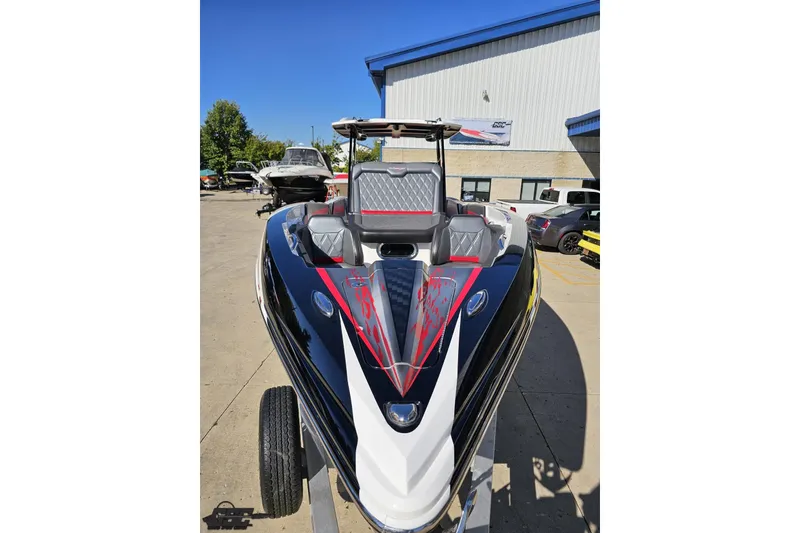 Slide: The Image of 2020 Sunsation 32 CCX boat with sleek design and modern features, parked outdoors. - 23