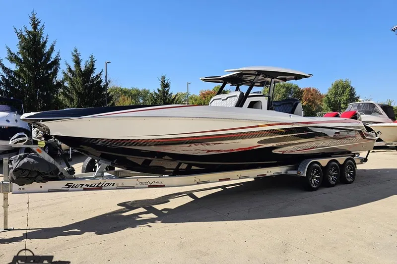 Slide: The Image of 2020 Sunsation 32 CCX boat on trailer, sleek design, parked outdoors. - 28