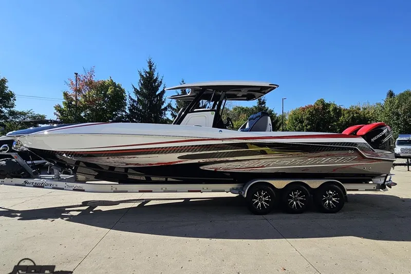 Slide: The Image of 2020 Sunsation 32 CCX boat on trailer, sleek design, vibrant graphics, outdoor setting. - 30