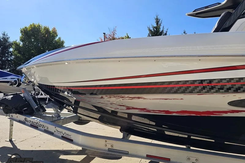 Slide: The Image of 2020 Sunsation 32 CCX boat on trailer, featuring sleek design and vibrant graphics. - 31