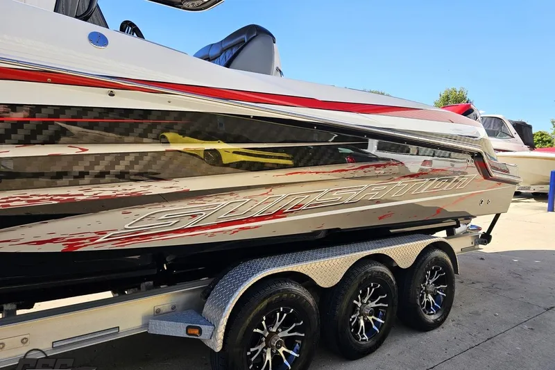 Slide: The Image of 2020 Sunsation 32 CCX boat on a trailer, featuring sleek design and vibrant graphics. - 32