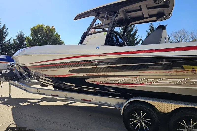 Slide: The Image of 2020 Sunsation 32 CCX boat on trailer, sleek design with red and black accents. - 33