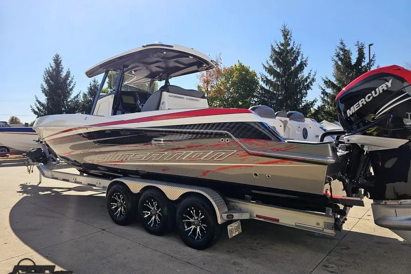 Slide: The Image of 2020 Sunsation 32 CCX boat on trailer with Mercury engines, parked outdoors. - 35
