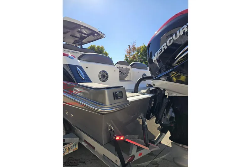 Slide: The Image of 2020 Sunsation 32 CCX boat with Mercury outboard engine, parked on a trailer. - 37