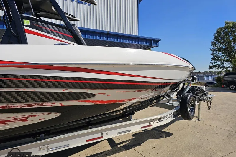 Slide: The Image of 2020 Sunsation 32 CCX boat with sleek red and black design on trailer. - 5