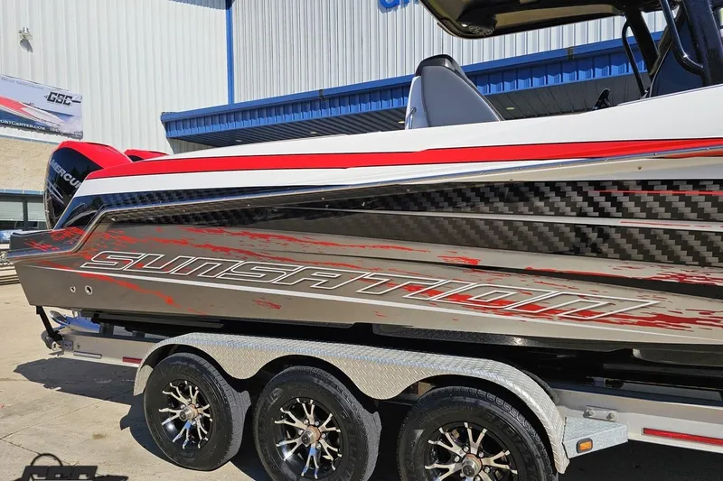 Slide: The Image of 2020 Sunsation 32 CCX boat on trailer, featuring sleek design and vibrant red accents. - 6