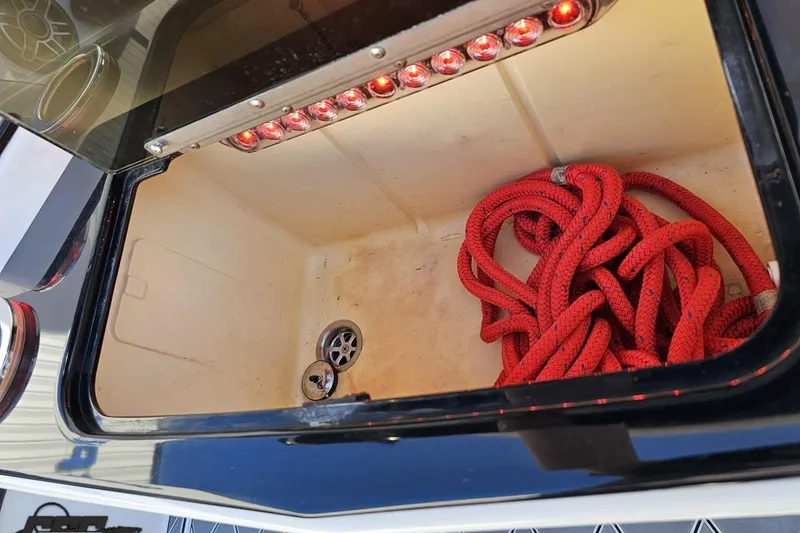 Slide: The Image of Storage compartment of 2020 Sunsation 32 CCX boat with red rope and LED lights. - 63
