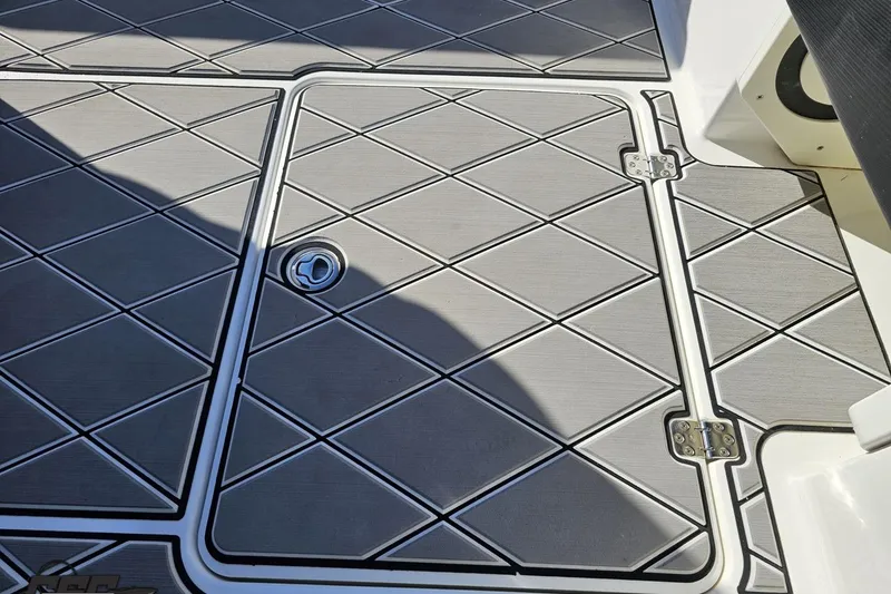 Slide: The Image of 2020 Sunsation 32 CCX boat deck with diamond-patterned flooring and hatch. - 66
