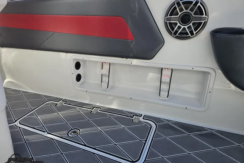 Slide: The Image of 2020 Sunsation 32 CCX interior with speaker, red and black accents, and storage compartment. - 68