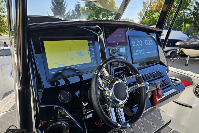Slide: The Image of Dashboard of 2020 Sunsation 32 CCX boat with navigation screens and steering wheel. - 75
